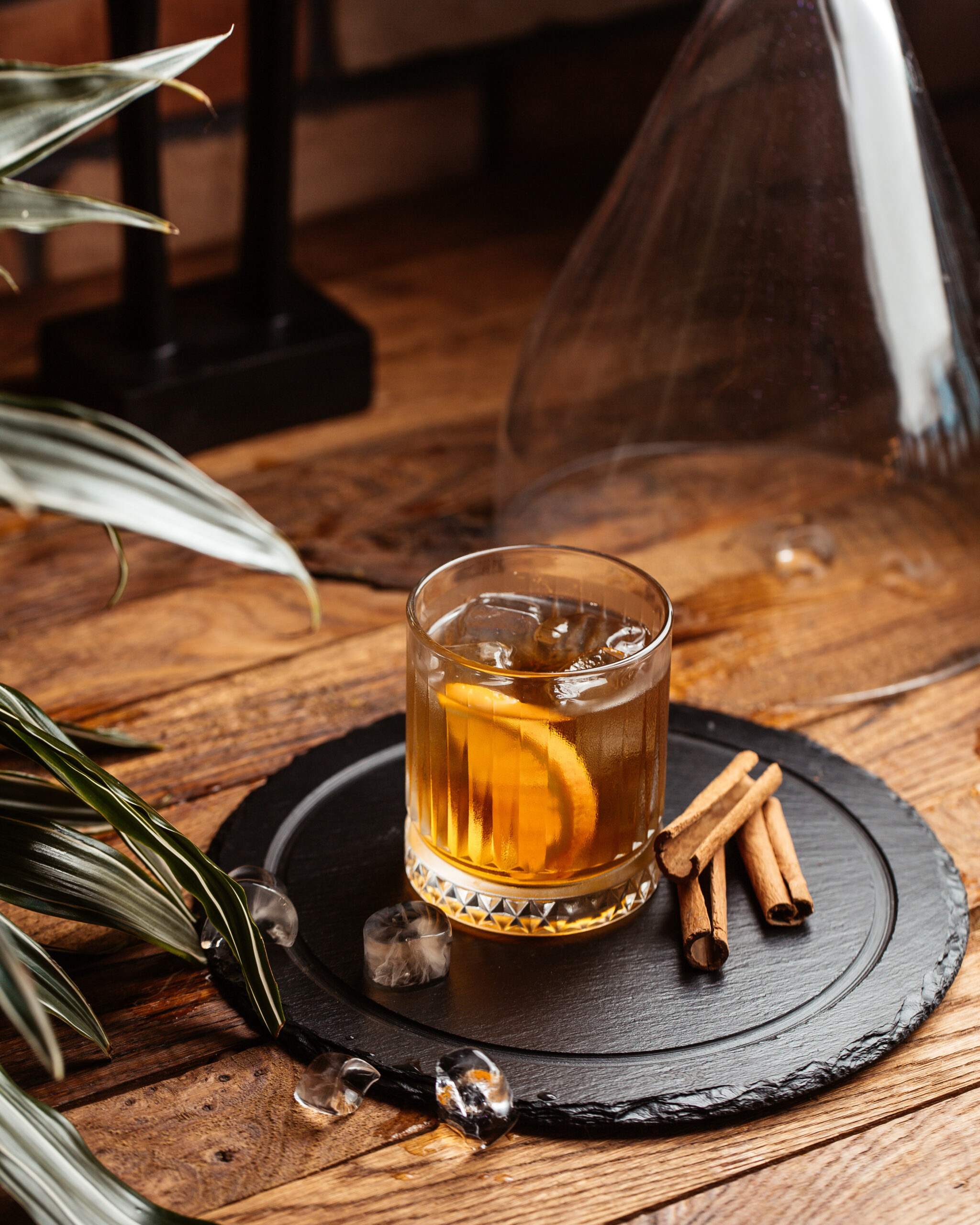 A glass of whisky drink called Old fashioned with cinnamon stick